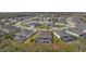 Aerial view of houses surrounding a lake with several screened-in pools and beautiful landscaping at 12715 Wheatgrass Ct, Parrish, FL 34219