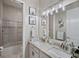Bathroom boasting double sinks, granite countertop, and tub/shower combo with decorative tile accent at 12715 Wheatgrass Ct, Parrish, FL 34219