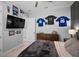 Bedroom with modern sporty decor, ceiling fan, plush carpet, and stylish furnishings at 12715 Wheatgrass Ct, Parrish, FL 34219