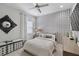 Cozy bedroom features modern wallpaper, plush carpet, a ceiling fan, and decorative furnishings at 12715 Wheatgrass Ct, Parrish, FL 34219