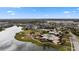 A relaxing community pool with surrounding landscaping, clubhouse, playground and lake views for residents to enjoy at 12715 Wheatgrass Ct, Parrish, FL 34219