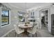 Cozy dining area with a round table, white chairs, and views of the backyard pool at 12715 Wheatgrass Ct, Parrish, FL 34219