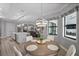 Bright dining area adjacent to kitchen and living spaces, featuring stylish chandelier and pool view at 12715 Wheatgrass Ct, Parrish, FL 34219