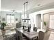 Stylish dining room that flows into living area, featuring coordinated decor and light floors at 12715 Wheatgrass Ct, Parrish, FL 34219
