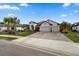 Single-Gathering home with well maintained lawn and a three-car garage at 12715 Wheatgrass Ct, Parrish, FL 34219