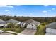Beautiful single-Gathering home boasts a three-car garage, paver driveway, and lush landscaping with palm trees at 12715 Wheatgrass Ct, Parrish, FL 34219