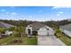 Well-manicured lawn leads to a home featuring a paver driveway and a 3-car garage at 12715 Wheatgrass Ct, Parrish, FL 34219