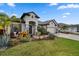 Charming front yard featuring professional landscaping, stone accents, and a well-manicured lawn at 12715 Wheatgrass Ct, Parrish, FL 34219