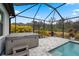 Relaxing hot tub area within a screened enclosure, nestled in lush greenery at 12715 Wheatgrass Ct, Parrish, FL 34219