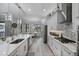 Bright kitchen featuring white cabinetry, stainless steel appliances, and adjacent breakfast nook at 12715 Wheatgrass Ct, Parrish, FL 34219