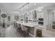 Modern kitchen featuring a large island, pendant lighting, and stainless steel appliances at 12715 Wheatgrass Ct, Parrish, FL 34219
