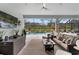 Inviting lanai with comfortable seating overlooking a sparkling pool and lush landscaping at 12715 Wheatgrass Ct, Parrish, FL 34219