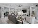 Open-concept living room with gray sofas, modern décor, and views into the dining area and entry at 12715 Wheatgrass Ct, Parrish, FL 34219