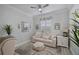 Cozy sitting room with neutral tones, comfortable seating, and natural light from shuttered windows at 12715 Wheatgrass Ct, Parrish, FL 34219