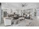 Bright, open living room showcasing neutral tones, modern furnishings, and seamless flow to kitchen at 12715 Wheatgrass Ct, Parrish, FL 34219