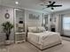 Bright main bedroom features carpet, stylish decor, ceiling fan, and lots of natural light at 12715 Wheatgrass Ct, Parrish, FL 34219