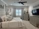 Spacious main bedroom featuring ceiling fan, window with shutters, and modern decor at 12715 Wheatgrass Ct, Parrish, FL 34219