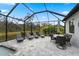Inviting pool deck with lounge chairs and a dining area within a screened enclosure at 12715 Wheatgrass Ct, Parrish, FL 34219