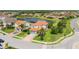 Aerial view of a landscaped home in a residential neighborhood with a nearby lake, showcasing its prime location at 13721 Saw Palm Creek Trl, Lakewood Ranch, FL 34211
