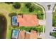 Aerial view showing the home's backyard with a pool, patio, and lush landscaping, backing onto a lake at 13721 Saw Palm Creek Trl, Lakewood Ranch, FL 34211