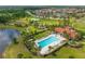 Aerial view of the community clubhouse, pool, and surrounding amenities, showcasing a luxurious lifestyle at 13721 Saw Palm Creek Trl, Lakewood Ranch, FL 34211