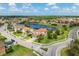 Aerial view of the neighborhood, with a view of the houses, streets, and the nearby lake at 13721 Saw Palm Creek Trl, Lakewood Ranch, FL 34211