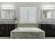 Elegant bathroom with granite countertops, and vanities, soaker tub and tiled backsplash at 13721 Saw Palm Creek Trl, Lakewood Ranch, FL 34211