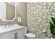 Charming powder room featuring patterned wallpaper, a stylish mirror, and a white vanity with modern fixtures at 13721 Saw Palm Creek Trl, Lakewood Ranch, FL 34211