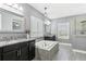This primary bathroom is designed with granite countertops and stylish fixtures at 13721 Saw Palm Creek Trl, Lakewood Ranch, FL 34211