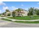 Expansive corner lot with a meticulously maintained lawn, mature trees, and elegant architectural detailing at 13721 Saw Palm Creek Trl, Lakewood Ranch, FL 34211