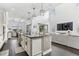 Bright, open kitchen with sleek black countertops, white cabinetry, and a seamless flow to the living area at 13721 Saw Palm Creek Trl, Lakewood Ranch, FL 34211