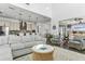 Bright living room with stylish furnishings flows into the open kitchen and dining area at 13721 Saw Palm Creek Trl, Lakewood Ranch, FL 34211