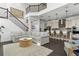 Open concept living area with kitchen, dining, and staircase with stylish decor at 13721 Saw Palm Creek Trl, Lakewood Ranch, FL 34211