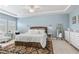 Spacious main bedroom with tray ceilings, bright light, and an ornate rug at 13721 Saw Palm Creek Trl, Lakewood Ranch, FL 34211