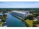 Stunning aerial view of waterfront condos with boat docks and lush landscaping at 1709 N Tamiami Trl # 318, Sarasota, FL 34234