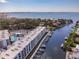 Stunning aerial view of waterfront condos with boat docks and beautiful bay views on a sunny day at 1709 N Tamiami Trl # 318, Sarasota, FL 34234