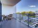 Balcony overlooking a waterfront canal with a table and chairs, perfect for relaxing outdoors at 1709 N Tamiami Trl # 318, Sarasota, FL 34234