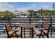 Relaxing outdoor balcony space with seating overlooking waterfront views and luxurious homes at 1709 N Tamiami Trl # 318, Sarasota, FL 34234