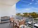 Balcony featuring seating with views of the tranquil waterfront and boat docks at 1709 N Tamiami Trl # 318, Sarasota, FL 34234