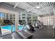Modern community gym with large windows overlooking the pool and other fitness equipment at 1709 N Tamiami Trl # 318, Sarasota, FL 34234