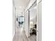 Hallway with barn door and laminate flooring, view of dining area and living room, modern design at 1709 N Tamiami Trl # 318, Sarasota, FL 34234