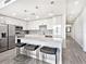 Open concept kitchen with stainless steel appliances, island seating, and modern finishes at 1709 N Tamiami Trl # 318, Sarasota, FL 34234