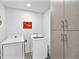 Laundry room featuring a front load washer and dryer, modern cabinets, and a minimalist design at 1709 N Tamiami Trl # 318, Sarasota, FL 34234