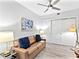 Living room featuring a ceiling fan, couch with decorative pillows, sliding closet doors and modern decor at 1709 N Tamiami Trl # 318, Sarasota, FL 34234