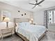Cozy main bedroom featuring a ceiling fan, neutral decor, and two side tables with lamps at 1709 N Tamiami Trl # 318, Sarasota, FL 34234