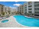Large free form community pool and whirlpool spa outside modern apartment buildings with balconies and lush landscaping at 1709 N Tamiami Trl # 318, Sarasota, FL 34234