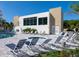 Community Pool Deck showcasing pool, jacuzzi, lounge chairs, gym, and modern architecture at 1709 N Tamiami Trl # 318, Sarasota, FL 34234