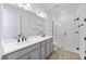 Modern bathroom featuring a double sink vanity, glass shower, and wood look tile floors at 172 Eagleston Ln, Sarasota, FL 34240