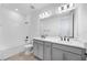 Bright bathroom featuring double vanity, white countertop, gray cabinets, and shower over tub at 172 Eagleston Ln, Sarasota, FL 34240