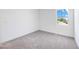 Empty bedroom featuring one window with an outside view, light grey carpet, and white walls at 172 Eagleston Ln, Sarasota, FL 34240